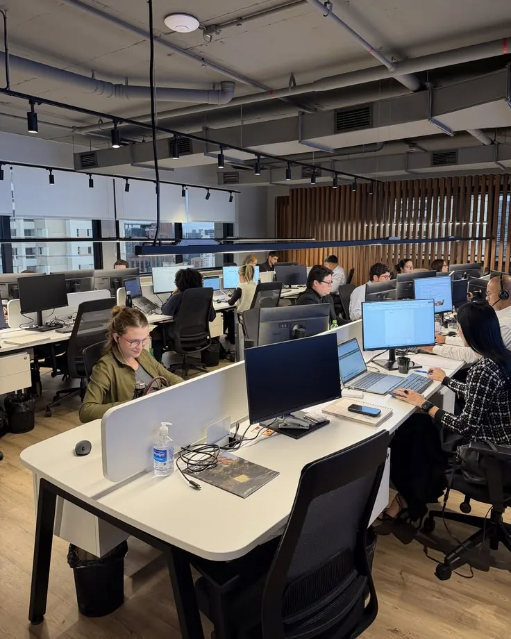 A modern open-plan office with people working at their desks